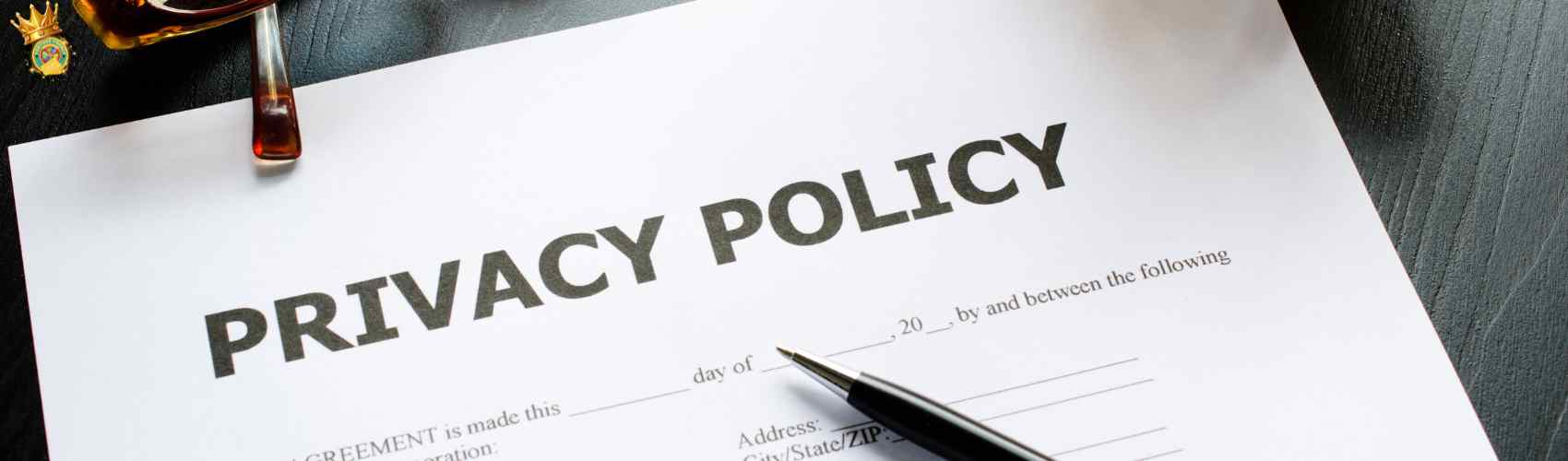 Close-up of a privacy policy document with a pen on a wooden table.